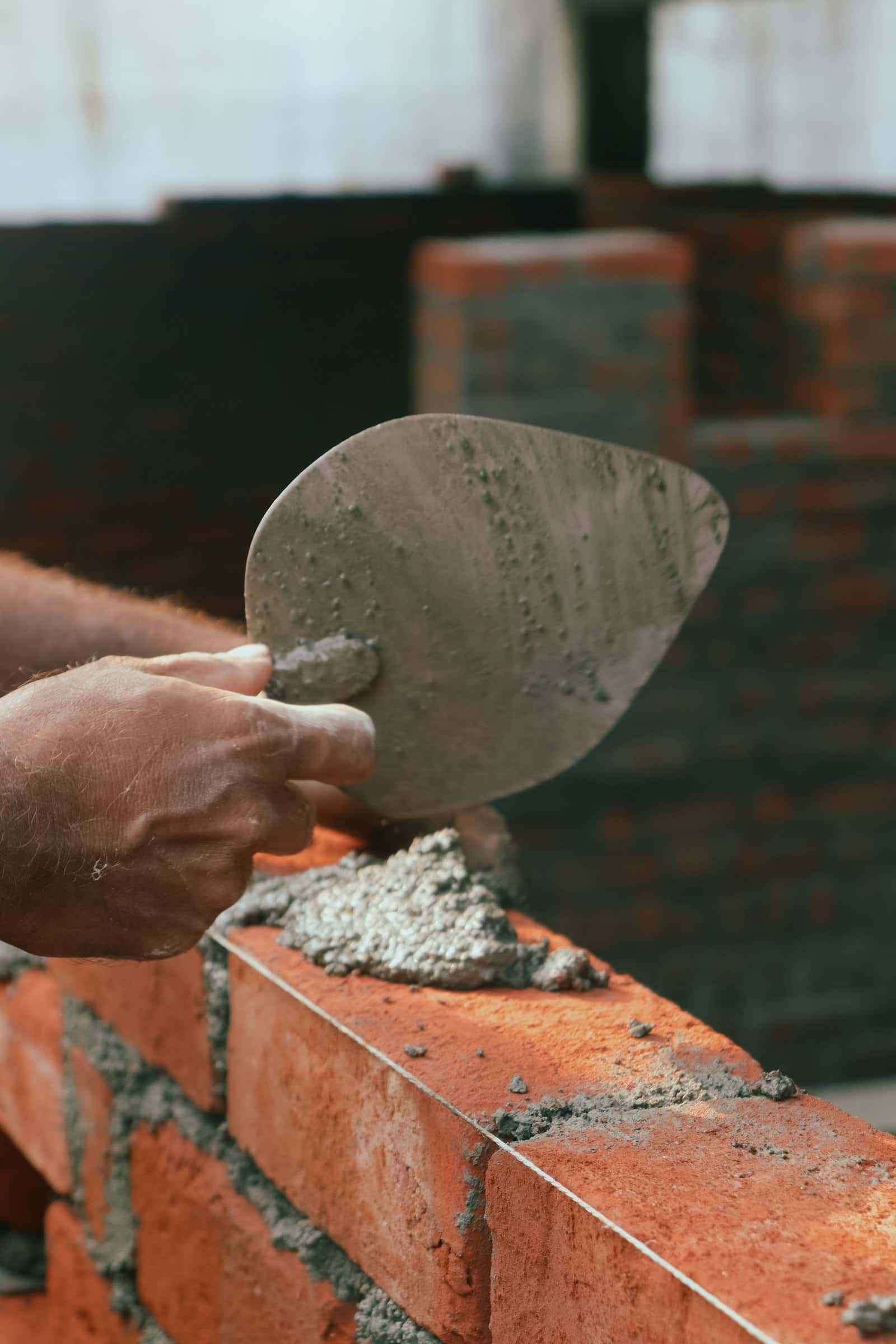 Mason spreading mortar with a trowel